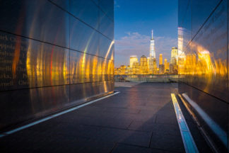 Empty Sky Memorial monument at night. View to Manhattan and illuminated One World Trade Center