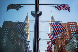 Chrisler building reflection with american flags, New york