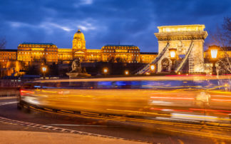 Budapest traffic over Chain bridge with Buda castle in the back