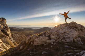 Hiker on mountain peak Velebit in Croatia