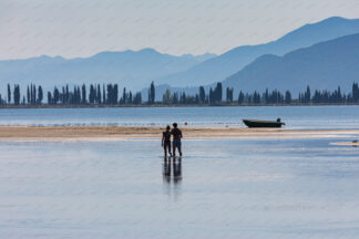 Couple walking in the shallow water of Delta Neretva