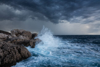 Sea storm, waves splashing Zarace rock, island Hvar