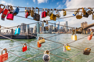 Love locks on Brooklyn waterfront, a view to Downtown Manhattan, New York