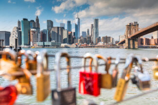 Love locks on Brooklyn waterfront, a view to Brooklyn bridge and Downtown Manhattan, New York