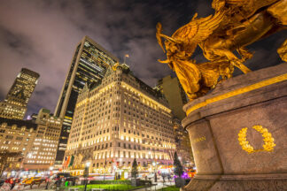 Statue of Augustus Saint-Gaudens on Grand Army Plaza at night in New York