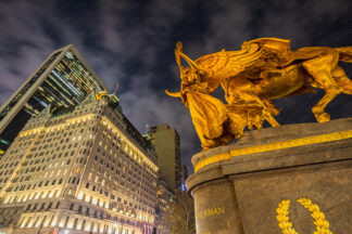 Statue of Augustus Saint-Gaudens on Grand Army Plaza at night in New York