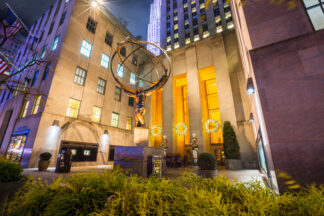 Atlas holding the globe at night in New York City