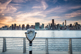 New York City skyline at sunset with old binoculars in front