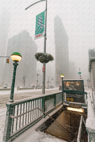 Metro station at snow storm near Flatiron building,  New York City