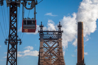 View to Queensboro bridge and Tram with steaming chimney in New York City