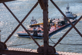 Tag boats tagging platform under Brooklyn Bridge