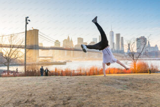 Hand stand in Dumbo park with a view to Brooklyn Bridge in New York City