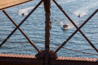 A view to the sailing ships trough the Brooklyn Bridge in New York City