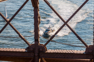 View to the Sailing ship trough the Brooklyn Bridge in New York City