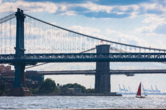 Saling on East river under Manhattan and Brooklyn Bridge