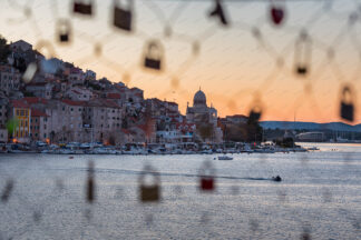 Sibenik panorama, a view trough the wire fence with love locks