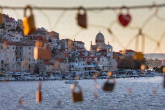 Sibenik panorama, a view trough the wire fence with love locks