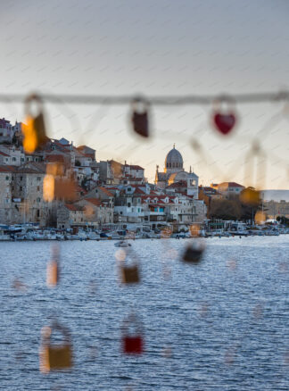 Sibenik panorama, a view trough the wire fence with love locks