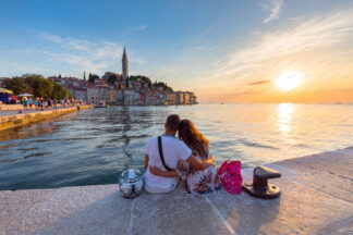 Couple watching Rovinj old town at sunset